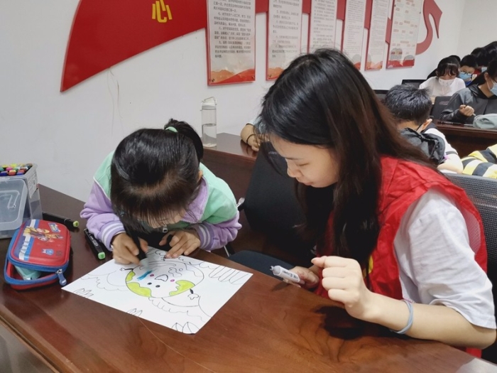集美大学生志愿者辅导小朋友绘制一张张多彩的画面，用行动对地球、对环境、对生活的热爱表达了出来.jpg